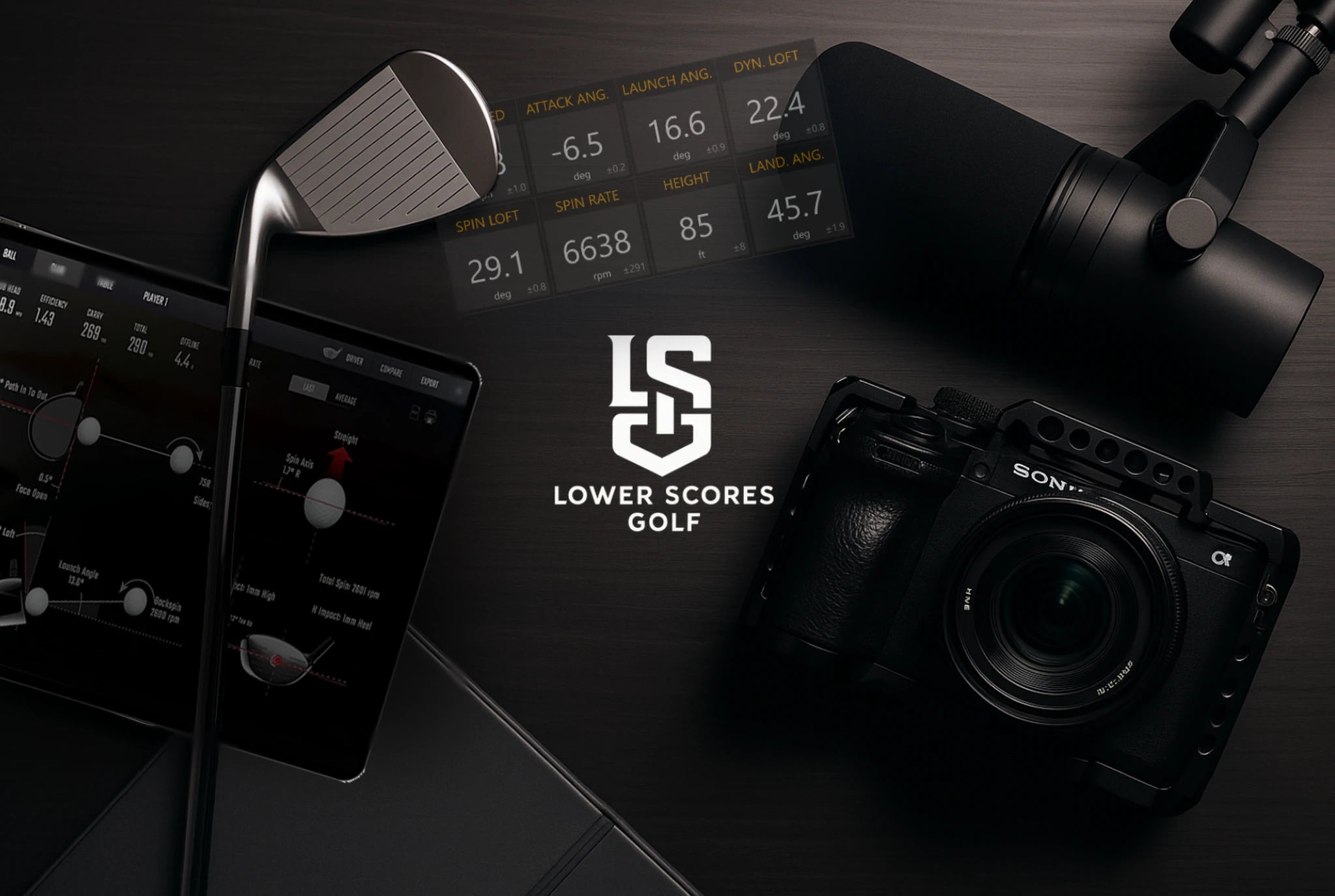 Golf technology setup with club, data display, and camera next to the Lower Scores Golf logo.